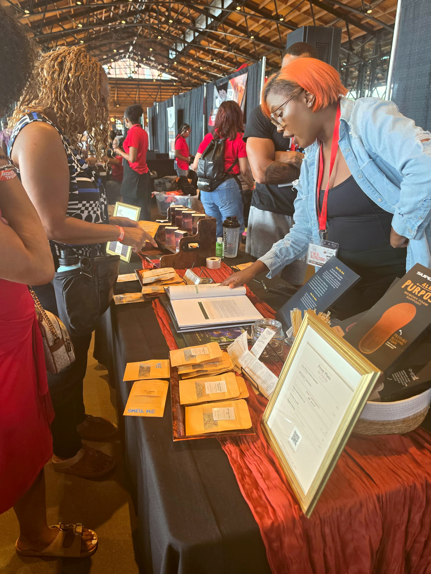 From Plate to Pelvis table at the Virginia Black Expo, with the cookbook, GeniTALES boxes, and wellness teas on display